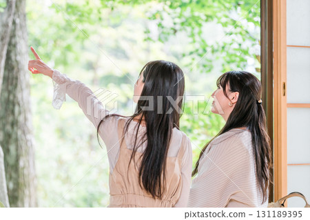 Young Asian woman on a girls trip to a ryokan or hot spring inn (travel, Japanese-style room, veranda) 131189395