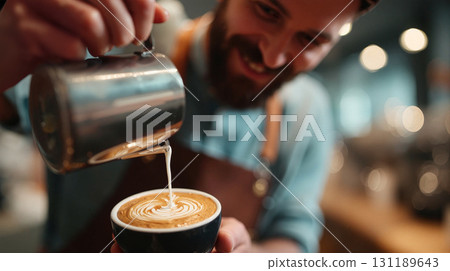 Smiling barista skillfully pouring latte art in a cozy cafe during the morning rush 131189643