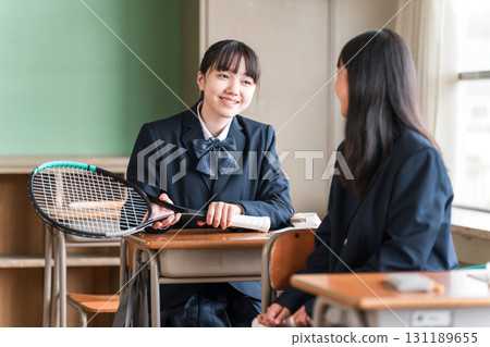 Junior high school girls having a conversation in a school classroom 131189655