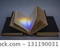 Open book with light reflection on pages, placed on stacked books 131190031