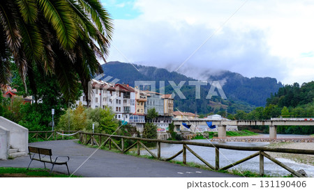 A picturesque video of the town of Arriondas in Asturias, Spain, with a tranquil river flowing through it. A picturesque video of the town of Arriondas in Asturias, Spain, with a tranquil river flowing through it. 131190406