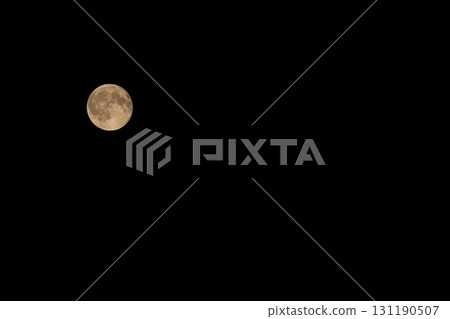 A full moon floating in the dark night, with even the craters visible 131190507