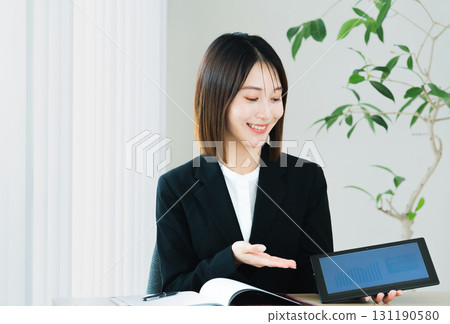 Business woman showing tablet Business woman showing tablet 131190580
