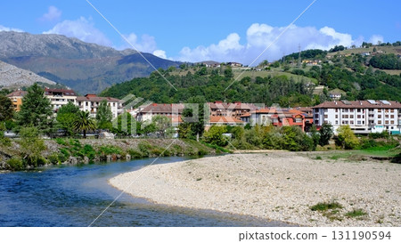 A picturesque video of the town of Arriondas in Asturias, Spain, with a tranquil river flowing through it. A picturesque video of the town of Arriondas in Asturias, Spain, with a tranquil river flowing through it. 131190594