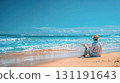 Man reading book on pristine tropical beach with turquoise waves and golden sand under clear blue sky, perfect peaceful vacation moment 131191643