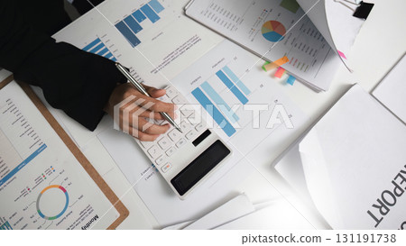 Calculator Use in Financial Analysis. Businesswoman Working on Reports. 131191738