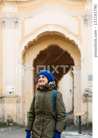Vilnius, Lithuania. Young Beautiful Pretty Caucasian Girl Woman Tourist Smiling On Background Holy Trinity Church And Basilian Gate 131191790