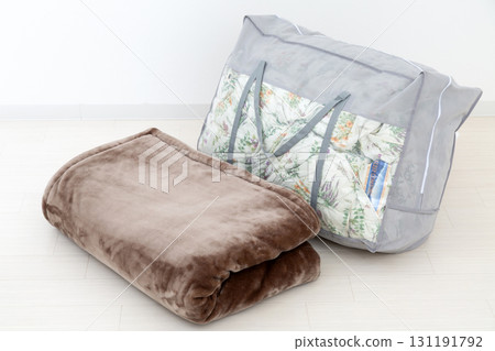 Down comforter and blanket in a storage bag 131191792