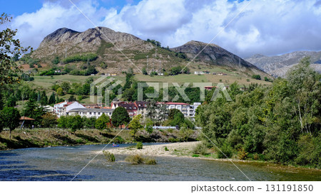 A picturesque video of the town of Arriondas in Asturias, Spain, with a tranquil river flowing through it. A picturesque video of the town of Arriondas in Asturias, Spain, with a tranquil river flowing through it. 131191850