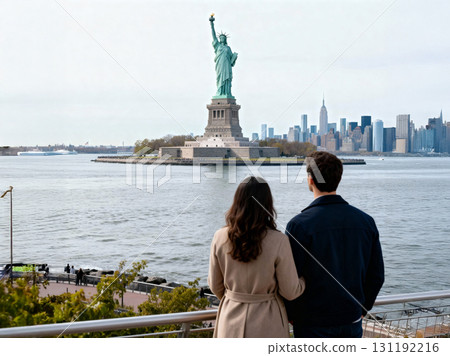 Couple enjoying the view of the Statue of Liberty and New York City skyline on a clear day 131192216