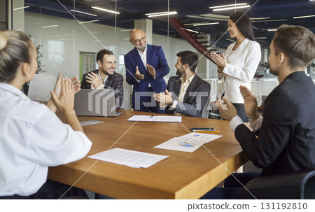 Team applauding during contract signing and celebration in office meeting Team applauding during contract signing and celebration in office meeting 131192810