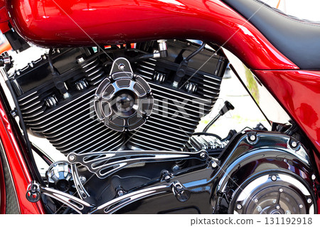 Motorcycle engine with chrome and black metal details. Mechanical parts highlight the craftsmanship, power, engineering of custom bike. For designs of transportation, mechanics, speed, lifestyle. 131192918