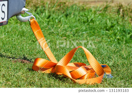 Tow hook with orange strap on car. Towing equipment. 131193183