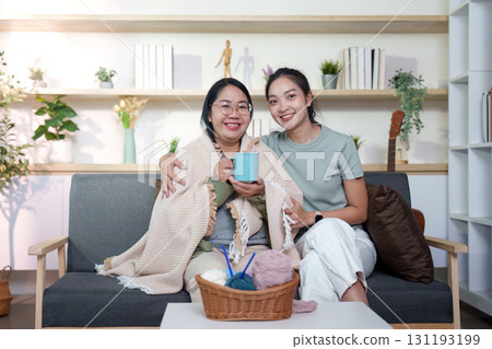 Bonding Moments: Two women enjoying tea and laughter at home Bonding Moments: Two women enjoying tea and laughter at home 131193199
