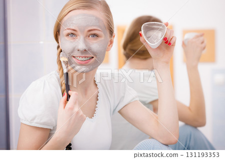 Woman with grey clay mud mask on her face 131193353
