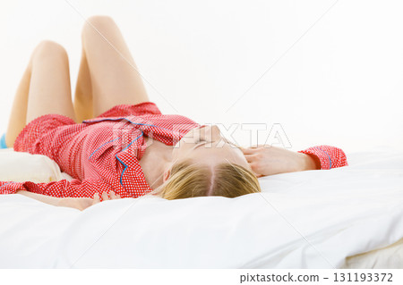 Woman sleeping in bed on back Woman sleeping in bed on back 131193372