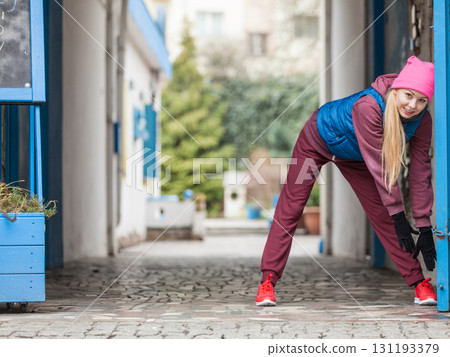 Sporty girl stretching outdoor on city street. Sporty girl stretching outdoor on city street. 131193379