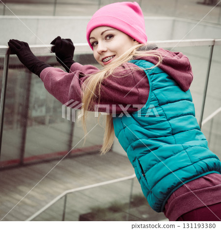 Sporty girl stretching outdoor on city street. 131193380