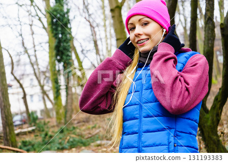 Teenage sporty girl listening to music outdoor. Teenage sporty girl listening to music outdoor. 131193383