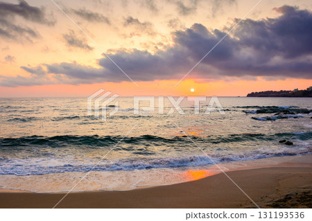 sea beach landscape on autumn sunrise. calm wave on sand shore. dramatic clouds above horizon. velvet season vacation in bulgaria sea beach landscape on autumn sunrise. calm wave on sand shore. dramatic clouds above horizon. velvet season vacation in bulgaria 131193536