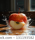 Red apple is sliced in half and is falling into a pool of water 131193582