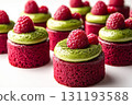 Row of red and green raspberry cupcakes with a green frosting 131193588