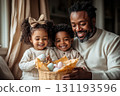 Man and two children are sitting on a couch, smiling 131193596