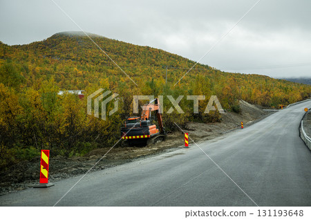 Excavator working on road construction in autumn forest landscape Excavator working on road construction in autumn forest landscape 131193648