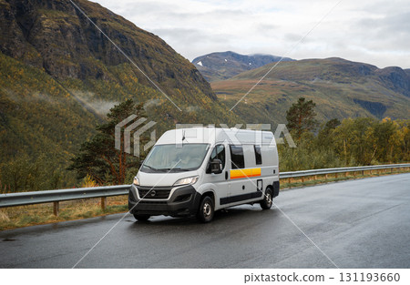 Camper van driving on mountain road in scenic landscape, Norway Camper van driving on mountain road in scenic landscape, Norway 131193660