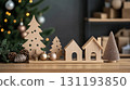 Wooden Christmas trees, houses, and ornaments on a wooden table with blurred festive background, Concept of sustainable holiday decor and craftwork, eco friendly, sustainable, zero waste 131193850