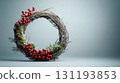 Handcrafted rustic wreath with red berries, pinecones, and green moss on a soft grey background,Christmas decor and craftwork, eco friendly, sustainable concept. Place for text. 131193853