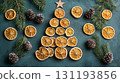Christmas tree shape created using dried orange slices, pine cones, and fir branches on a textured background. Christmas decor and craftwork, eco friendly, sustainable concept. 131193856