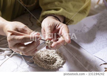 A woman knitting lace A woman knitting lace 131194242