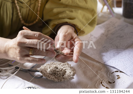 A woman knitting lace 131194244