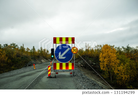 Traffic sign and green light at road construction site with speed limit 30 131194299