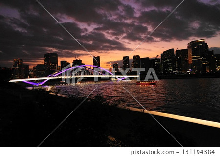 The illuminated Tsukiji Bridge and Tokyo Tower shine in the sunset. September 903 Tokyo Tower and Tsukiji Bridge at dusk The illuminated Tsukiji Bridge and Tokyo Tower shine in the sunset. September 903 Tokyo Tower and Tsukiji Bridge at dusk 131194384