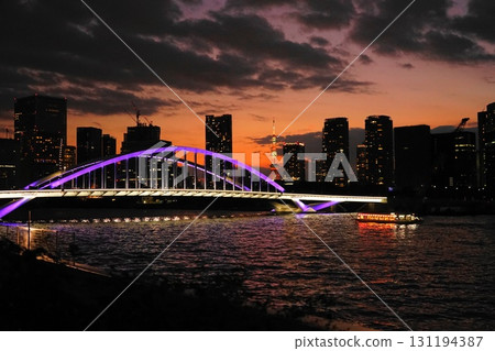 The illuminated Tsukiji Bridge and Tokyo Tower shine in the sunset. September 906 Tokyo Tower and Tsukiji Bridge at dusk 131194387