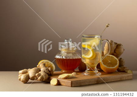 Ginger tea with lemon and honey on a beige background. 131194432