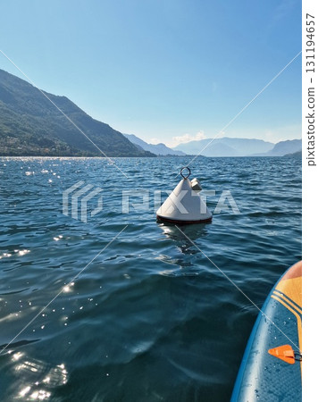 View of a buoy from a paddleboard on a lake 131194657