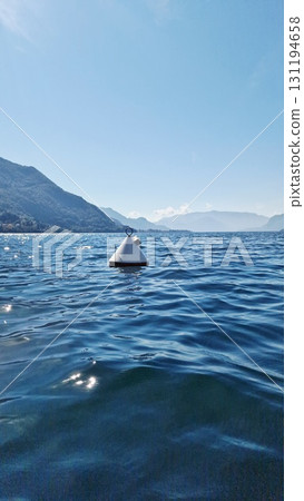 White buoy floating on blue lake 131194658