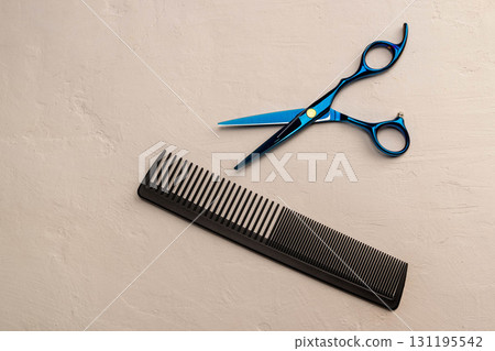 Hairdressing scissors and comb on light background Hairdressing scissors and comb on light background 131195542