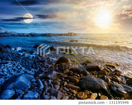 pebble coast. day and night time change concept. beautiful summer vacation season at the sea with sun and moon at twilight pebble coast. day and night time change concept. beautiful summer vacation season at the sea with sun and moon at twilight 131195946