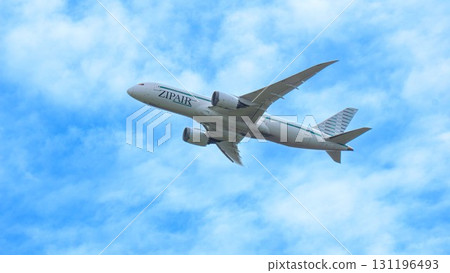 An airplane flying in the blue sky and clouds; ZIPAIR An airplane flying in the blue sky and clouds; ZIPAIR 131196493
