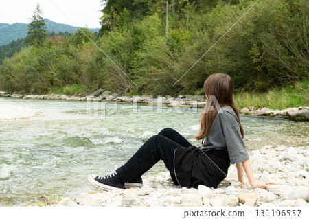 Teen Girl Walking Along the River in Nature 131196557