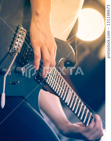 Close up of man playing on electric guitar 131196673