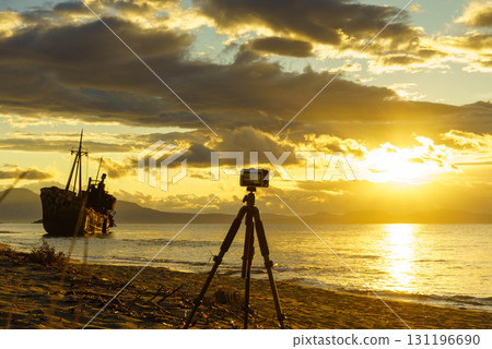 Camera on tripod and shipwreck 131196690