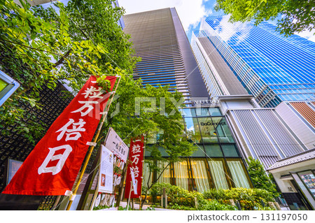 Tokyo cityscape in Japan. In front of the torii gate of Fukutoku Shrine in Nihonbashi Muromachi... Ichiritsu Manbai Day... May this wish bear fruit a million times over... 131197050