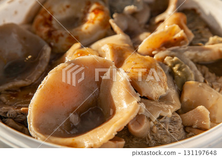 Altai salted mushrooms gruzd - milk mushroom in a plastic bucket at the fair Altai salted mushrooms gruzd - milk mushroom in a plastic bucket at the fair 131197648