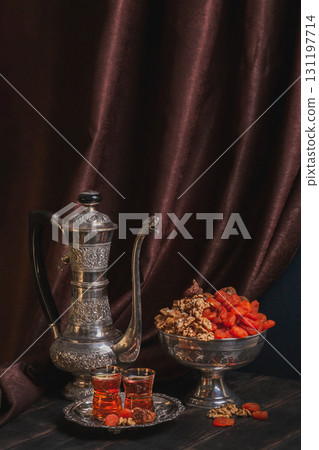Ancient East metallic crockery - vintage jug, vase with dried fruit and plate with tea in armuda glasses 131197714