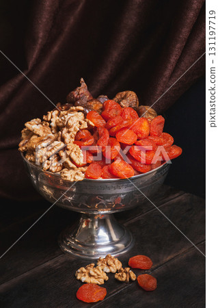 Vase with dried fruit and nuts. Still life with Ancient East metallic crockery Vase with dried fruit and nuts. Still life with Ancient East metallic crockery 131197719